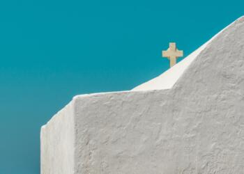 white cross on gray concrete wall