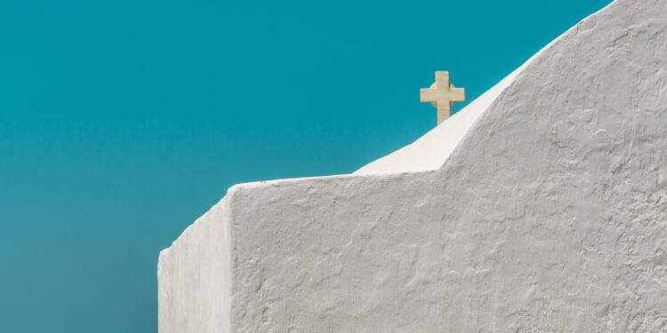 white cross on gray concrete wall