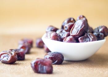 brown round fruit on white ceramic bowl