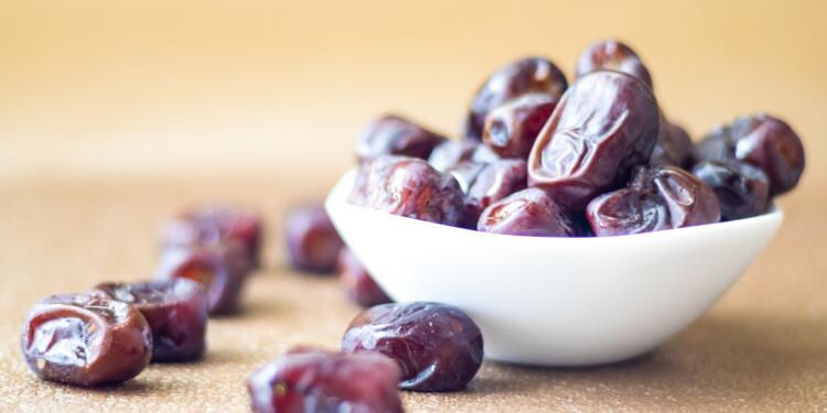 brown round fruit on white ceramic bowl