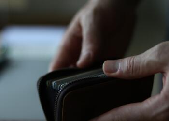 a person holding a wallet in their hand
