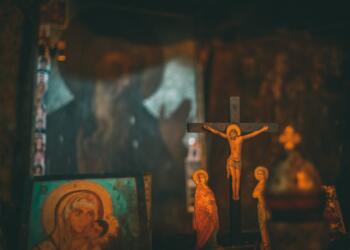 brown wooden crucifix on brown wooden wall
