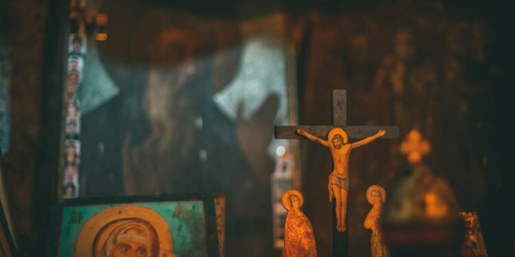 brown wooden crucifix on brown wooden wall