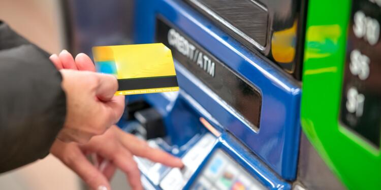 a person using a credit card to pay for a machine