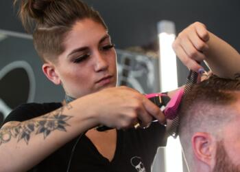 man in black crew neck t-shirt holding hair brush
