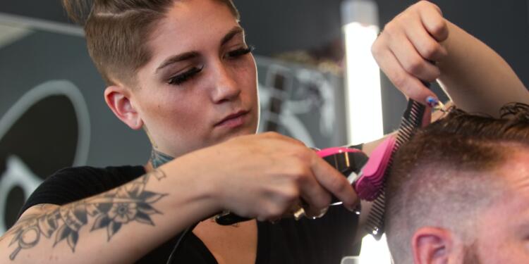 man in black crew neck t-shirt holding hair brush