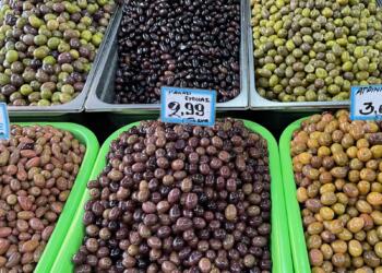 a display of olives for sale in a grocery store