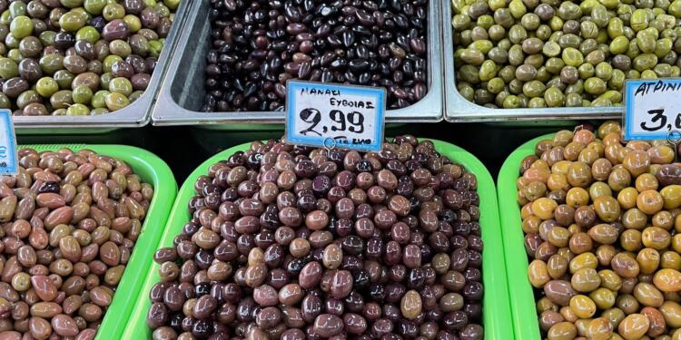 a display of olives for sale in a grocery store