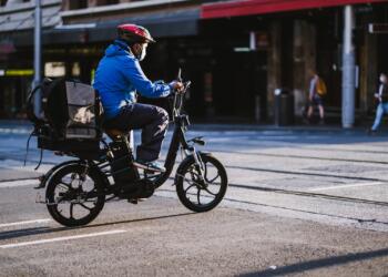 Man in Blue Jacket Riding Motorcycle on Road