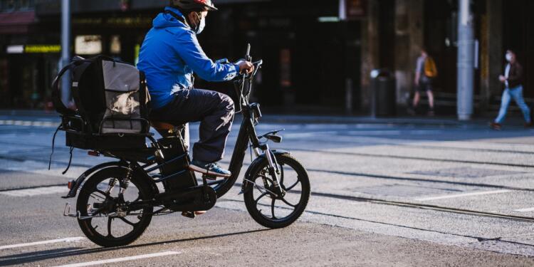 Man in Blue Jacket Riding Motorcycle on Road