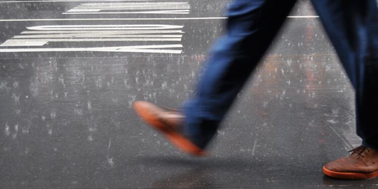 man wearing blue pants walking on street
