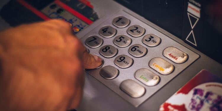 Person Pressing Keys of an ATM
