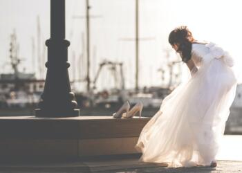 woman taking off her shoe near post