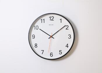 round analog wall clock pointing at 10:09