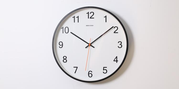 round analog wall clock pointing at 10:09