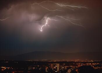 lightning strike over the city during night time