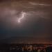 lightning strike over the city during night time