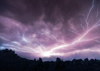 silhouette of mountain under cloudy sky during daytime