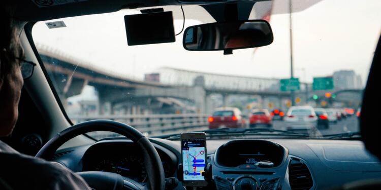 man driving vehicle with GPS system turned on